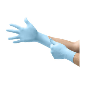 Person wearing light blue disposable gloves