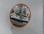 Food processing stainless steel mirror mounted on a wall