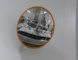 Food processing stainless steel mirror mounted on a wall