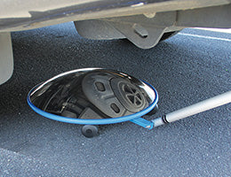 Telescopic lookunder inspection mirror on castor wheels checking under a vehicle