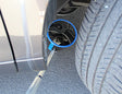 Telescopic portable inspection mirror in use checking under a vehicle
